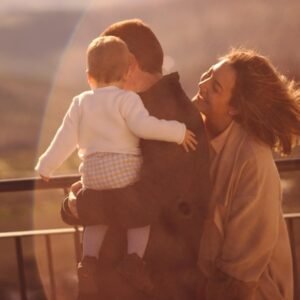 man in white dress shirt carrying girl in black dress