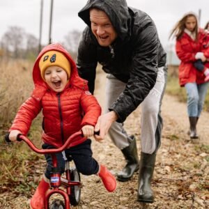 father teaching his son how to ride a bike